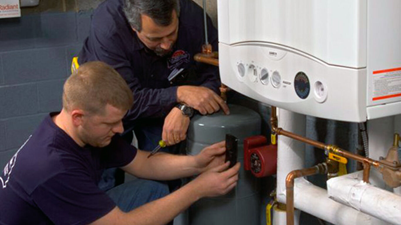 Two men installing water heating system in a church.