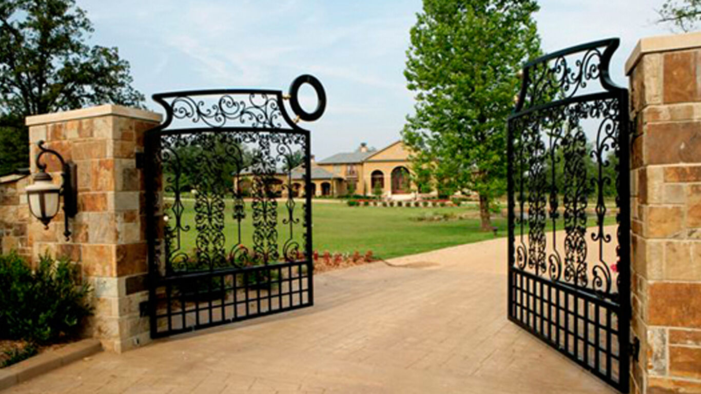 Two gates opening to a large house