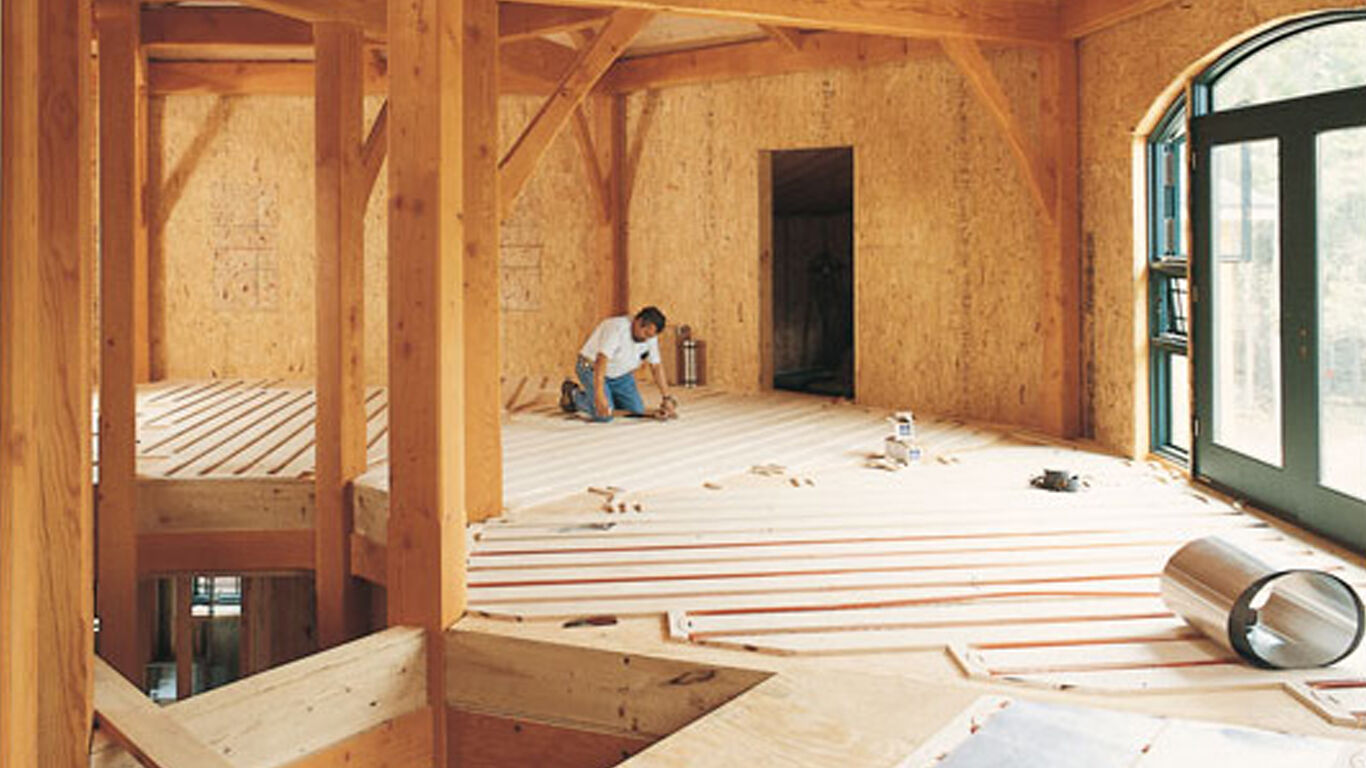 Man installing flooring onto a lighthouse floor. 