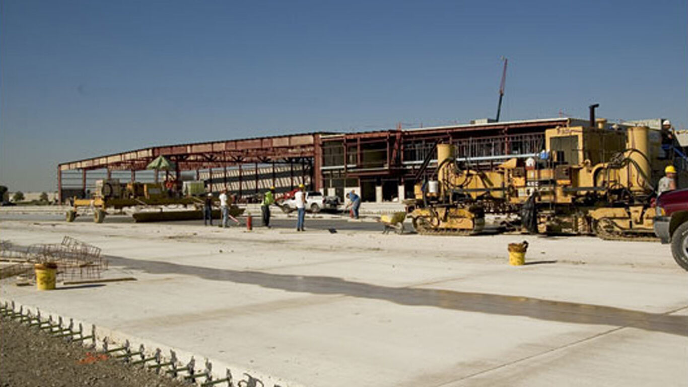 concrete being poured at a ware house that is being built