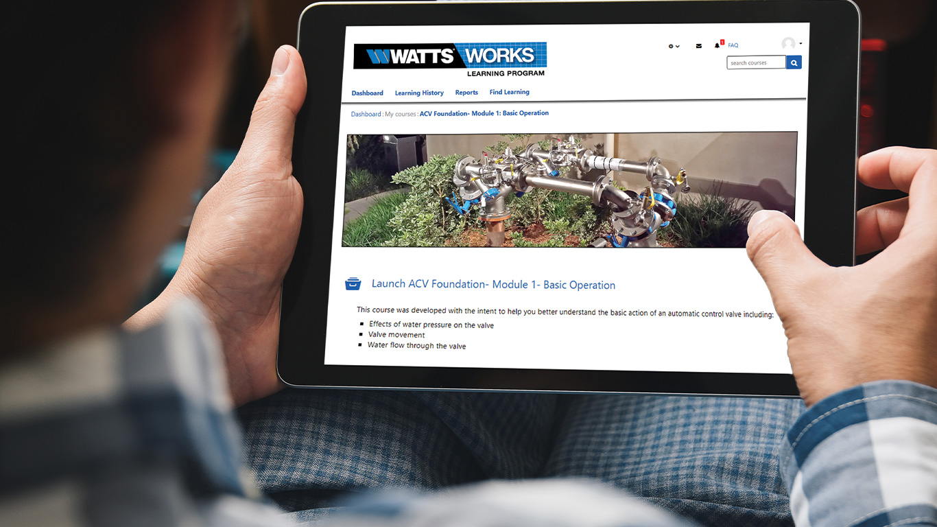 Man on his iPad to access the Basic Operation module for a Watts automatic control valve through the Watts Works learning program